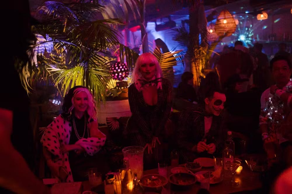 a group of people sitting at a table at night