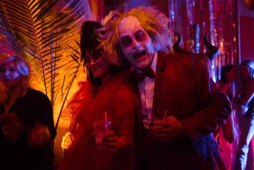 a group of people sitting at a table at night