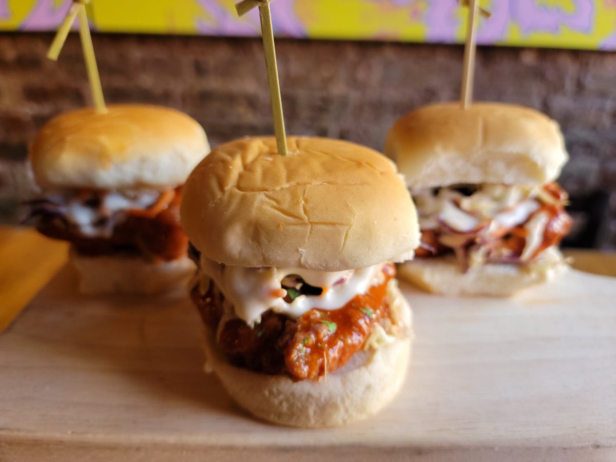 a close up of a sandwich sitting on top of a wooden table