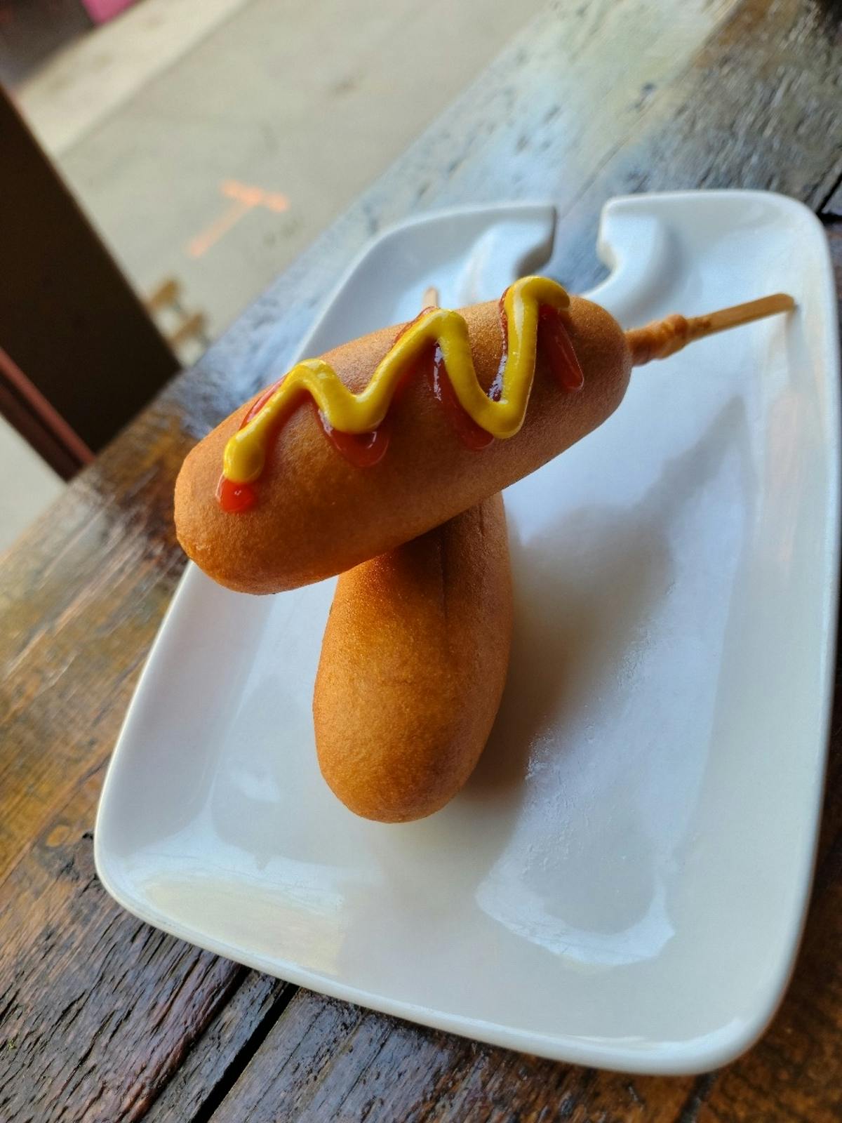 a plate of hot dogs sitting on a table