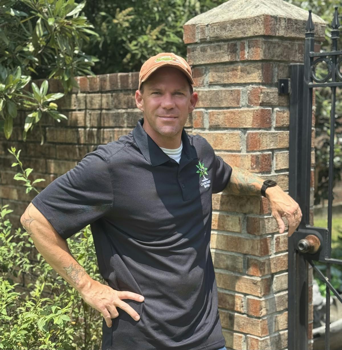 a man standing in front of a brick building
