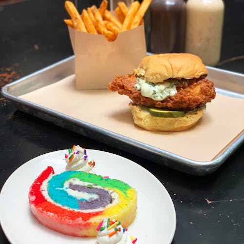 a plate of food with a slice of cake on a table