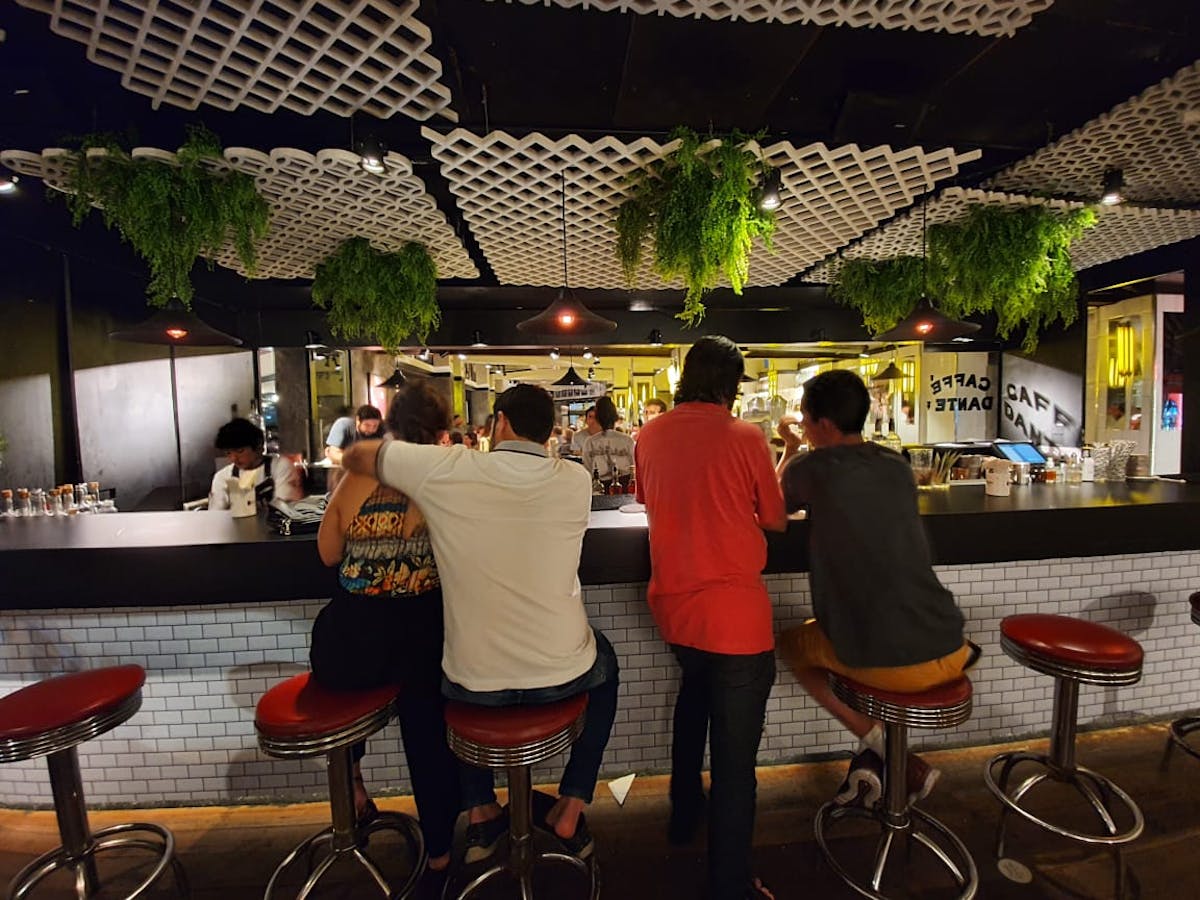 a group of people standing around a table