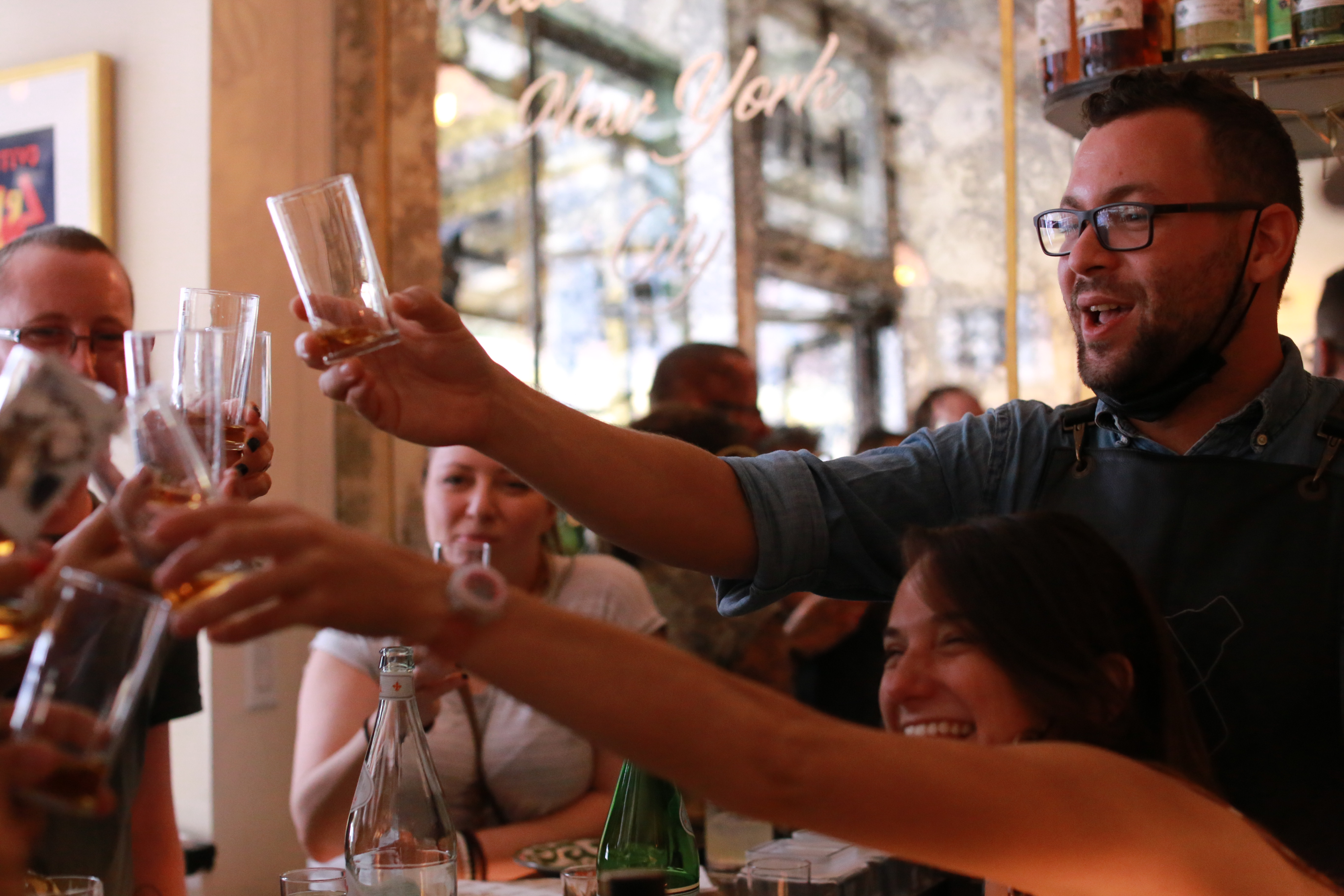 a group of people holding wine glasses