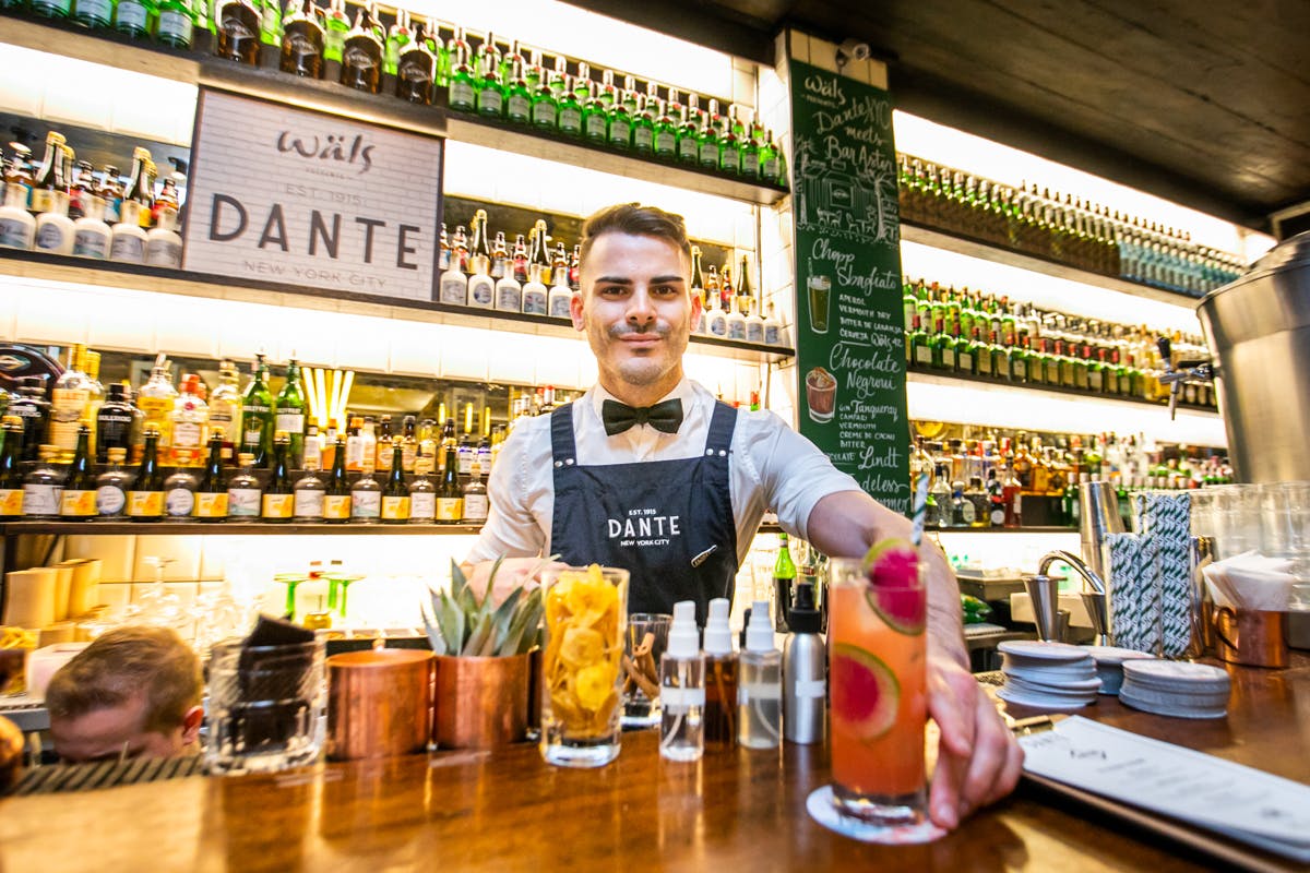 a bartender displaying cocktails