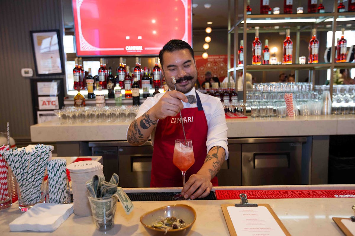 a bartender serving a cocktail