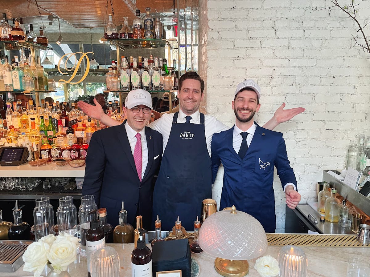 a couple of people that are standing in front of a table
