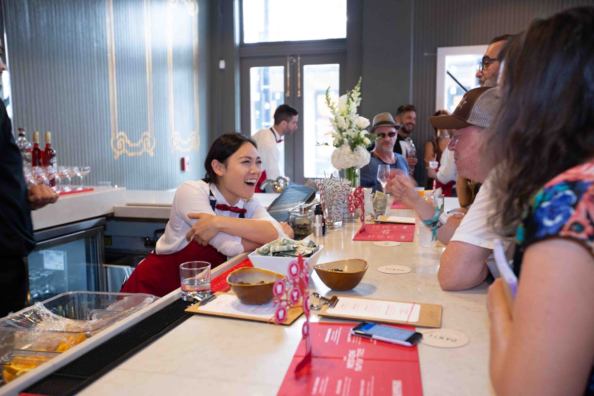 a group of people sitting at a table eating food