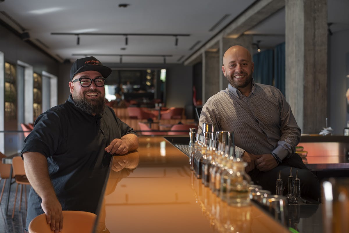 a man standing at a counter in a bar