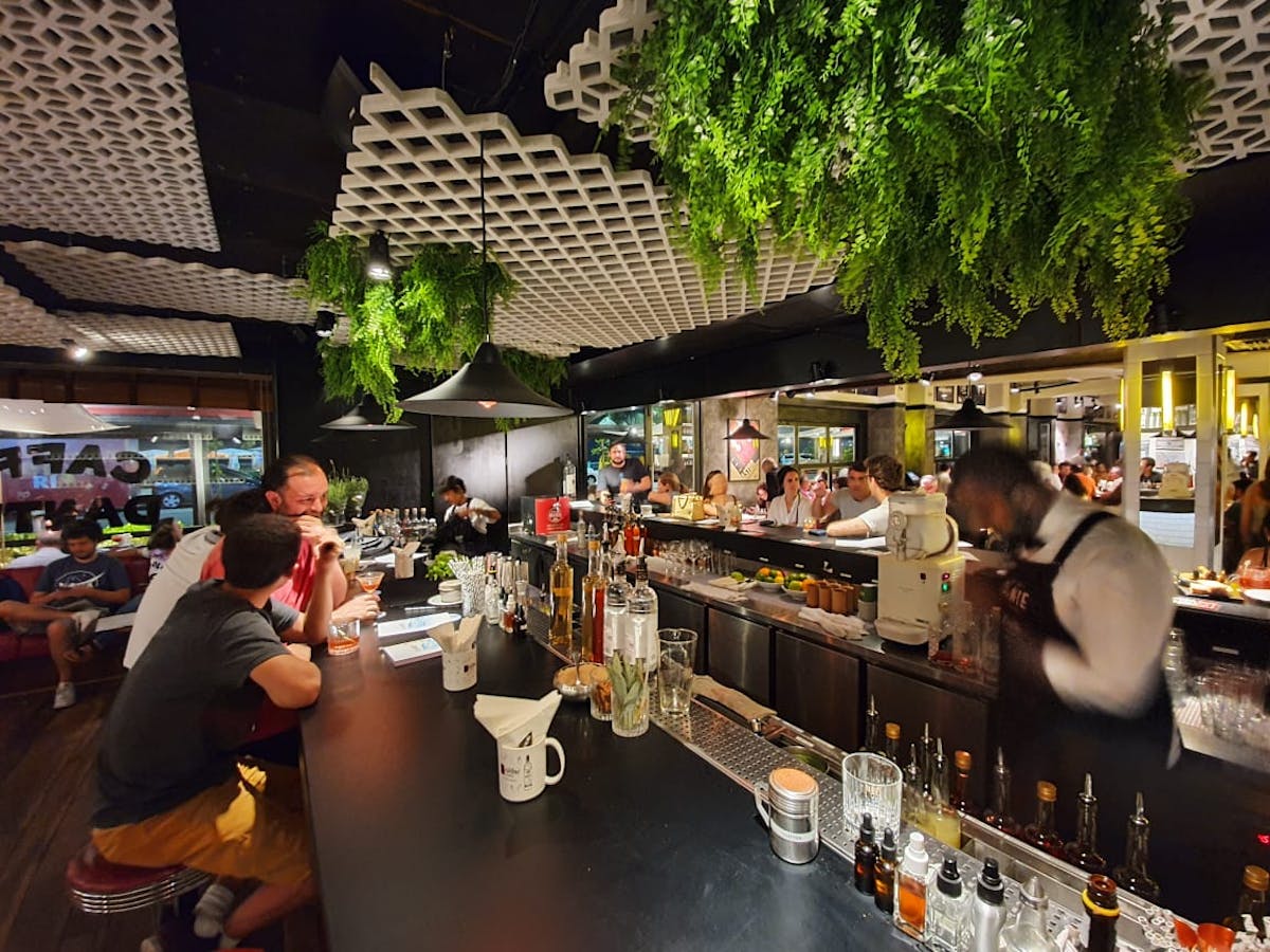 a group of people sitting at a table in a restaurant