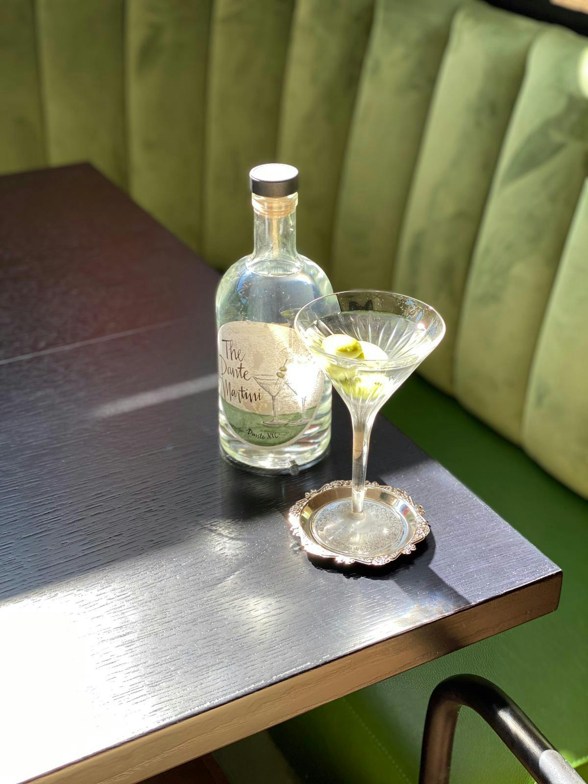 a glass of wine sitting on top of a wooden table