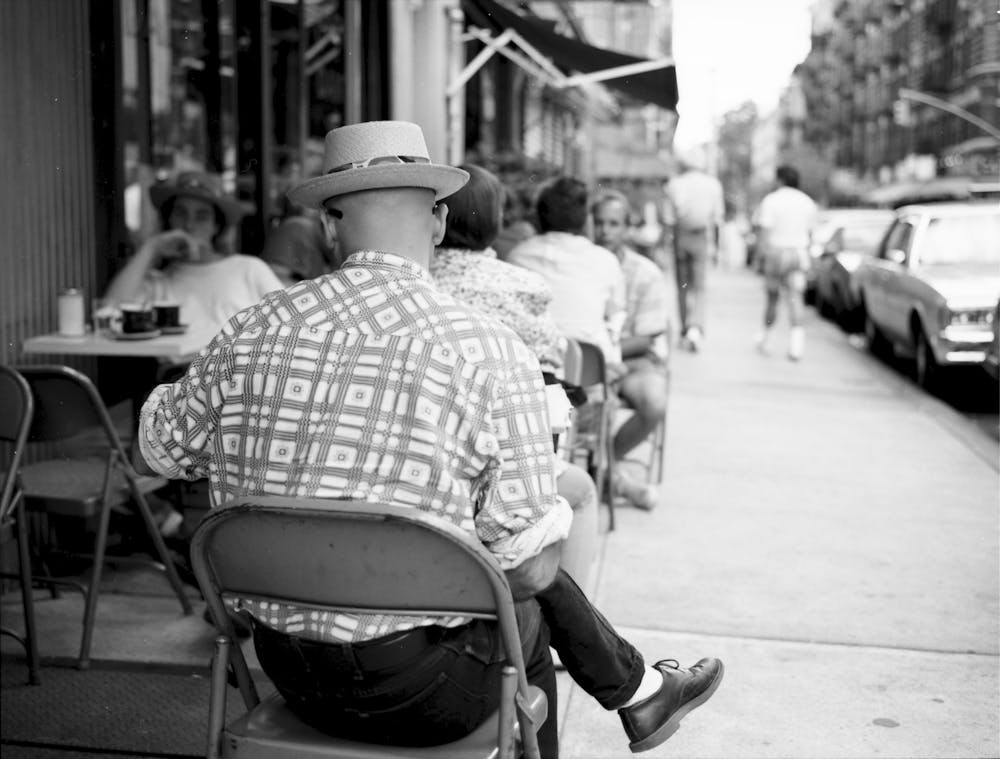 a person sitting on a sidewalk