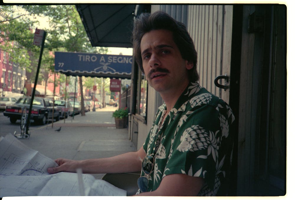 a man sitting at a bus stop