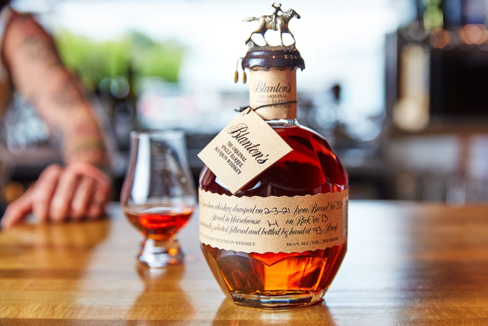 a close up of a bottle on a wooden table