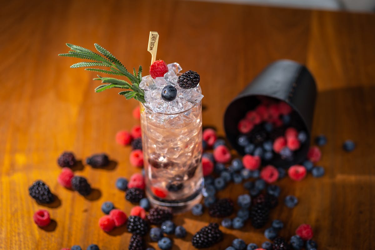 a cocktail and some fruits on a table