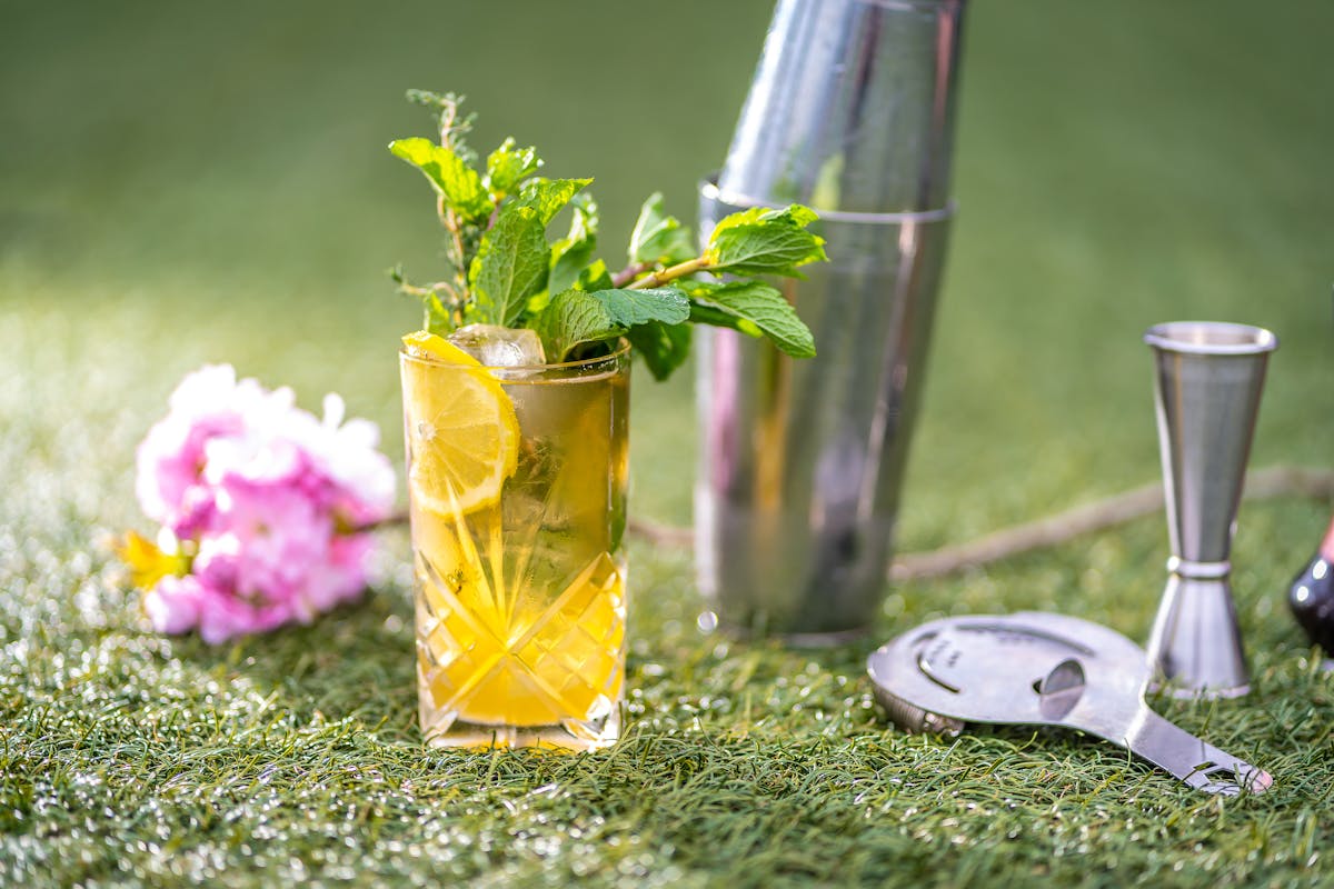 a cocktail on a green surface