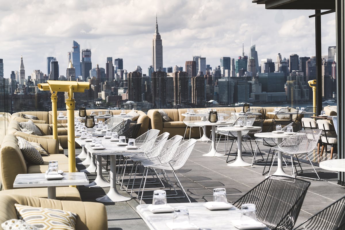 a large outdoors area filled with dining tables and chairs