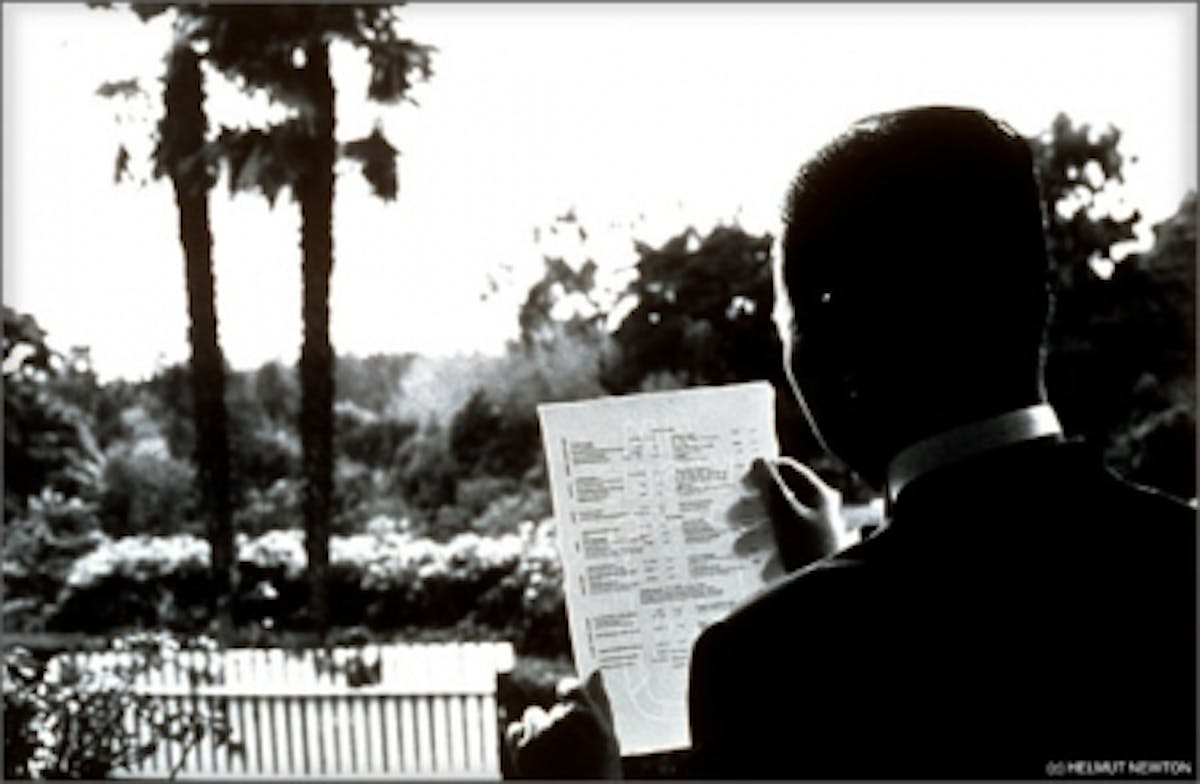 a man sitting in front of a laptop