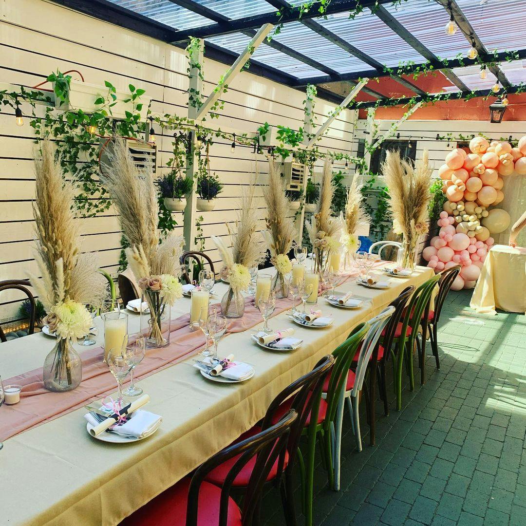 a table with plates and flowers for a private event
