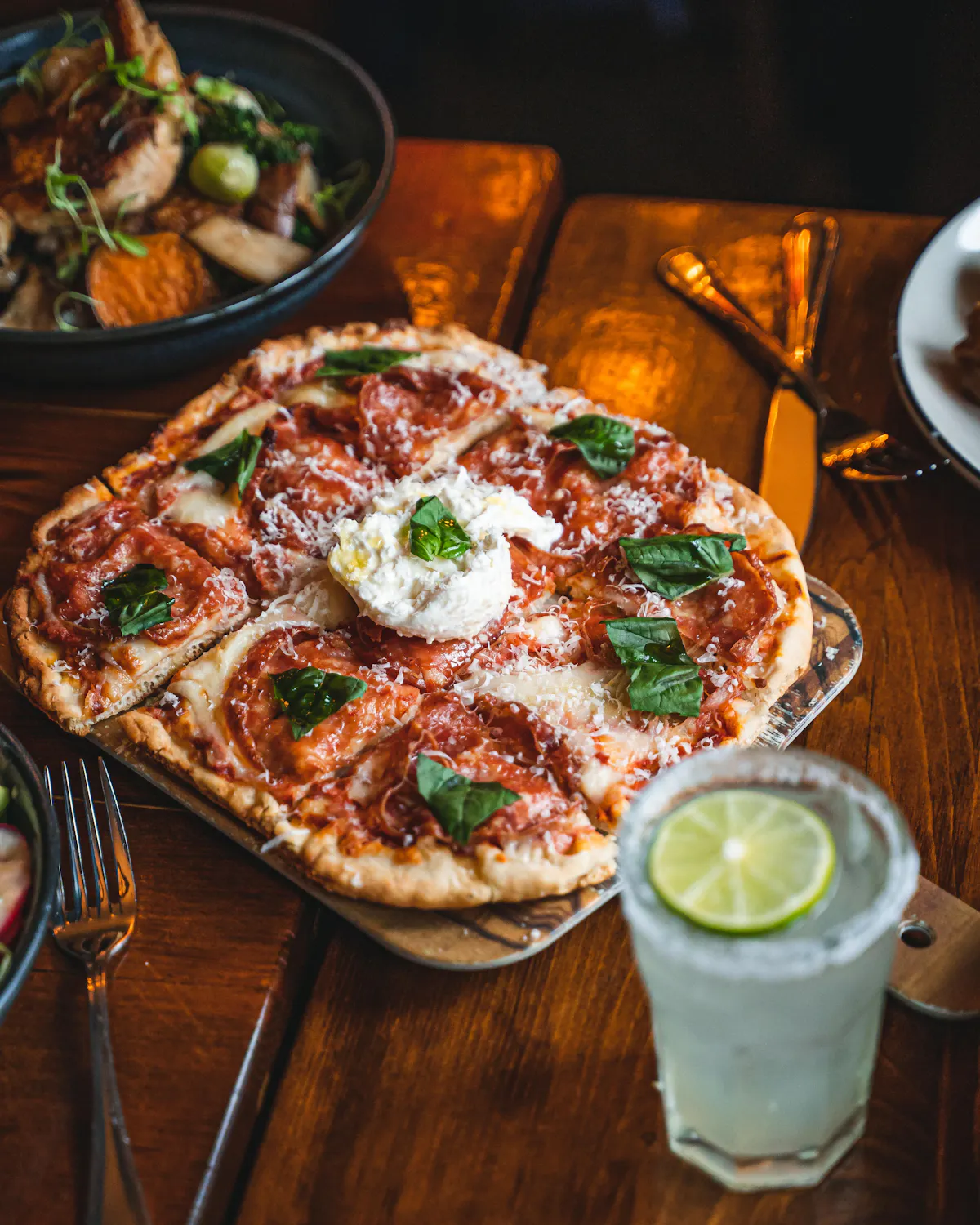 a pizza sitting on top of a wooden table