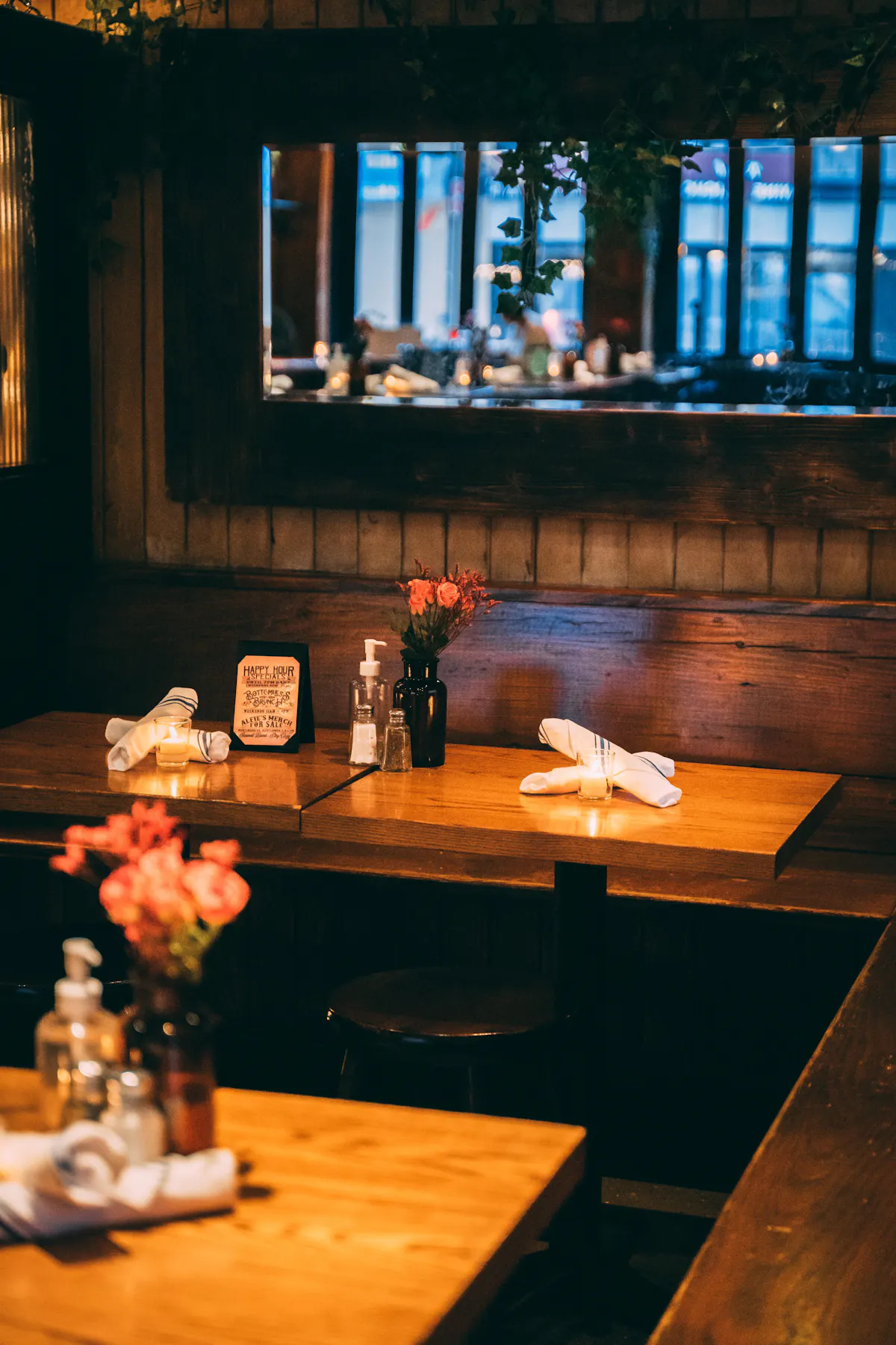 a room filled with furniture and vase of flowers on a wooden table