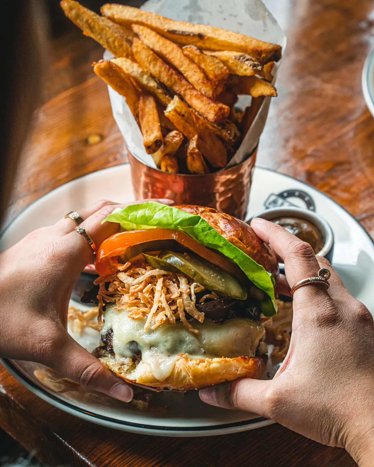 a plate of food with a sandwich and fries on a table