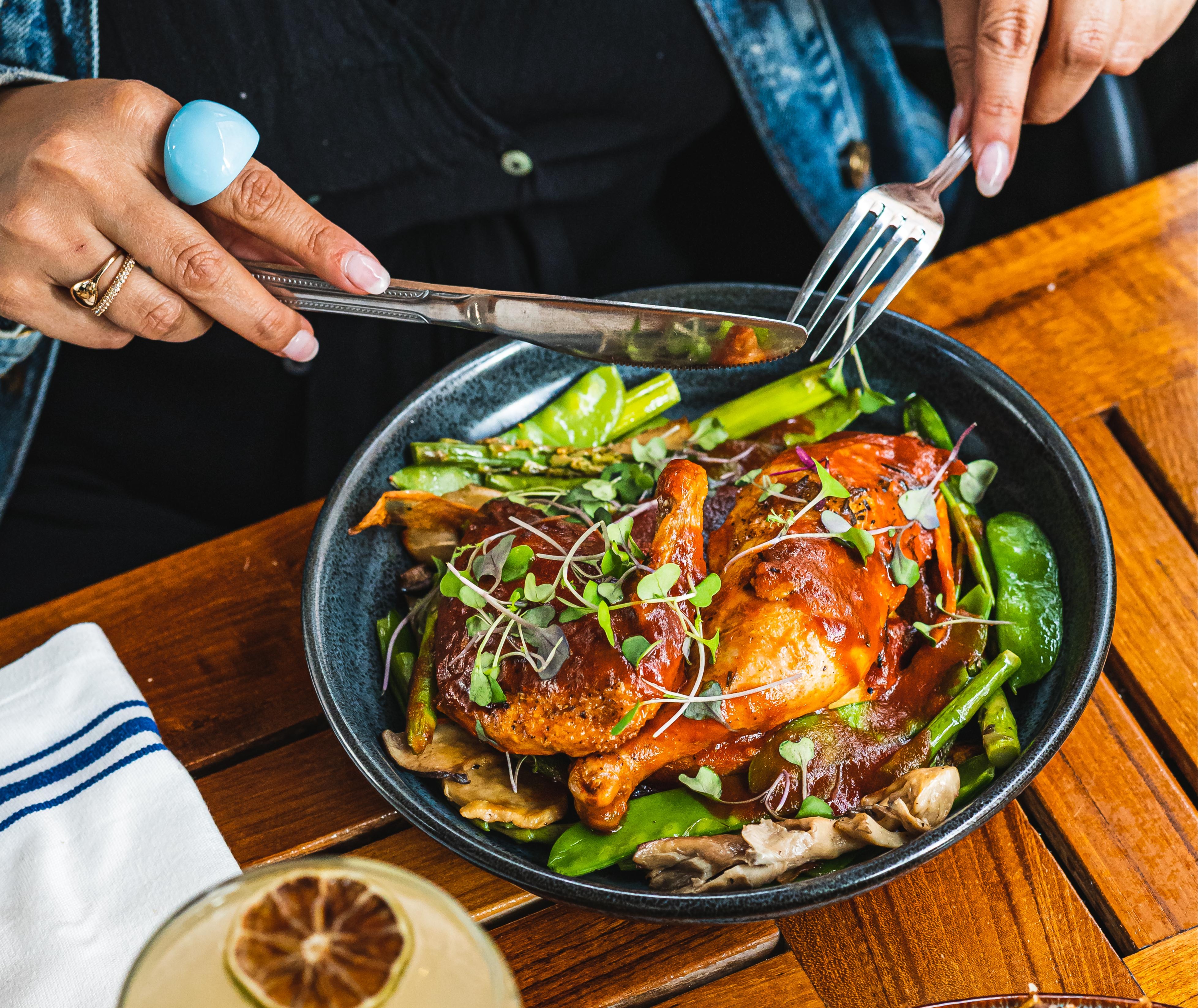 a person sitting at a table with a plate of food
