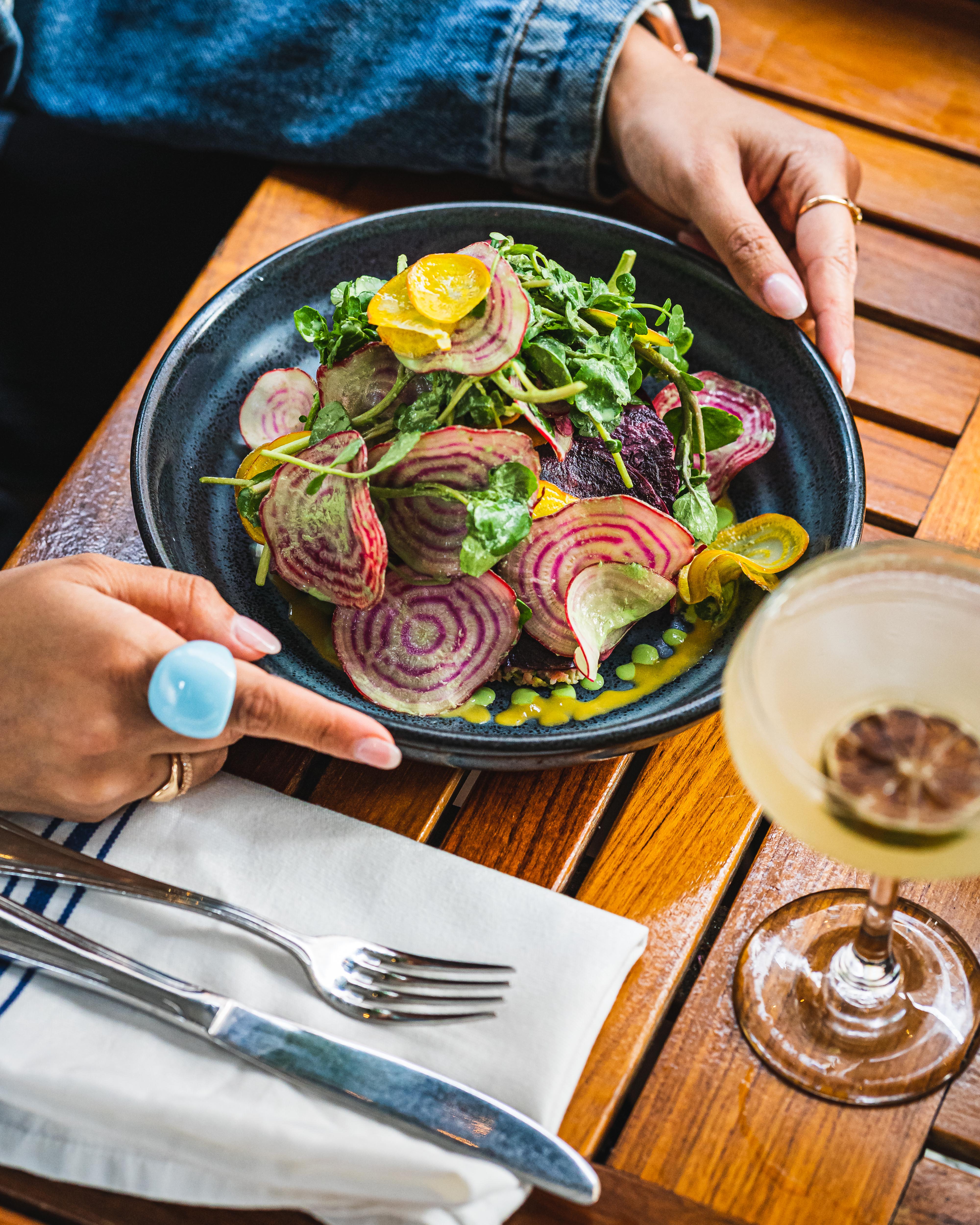 a person sitting at a table with a plate of food