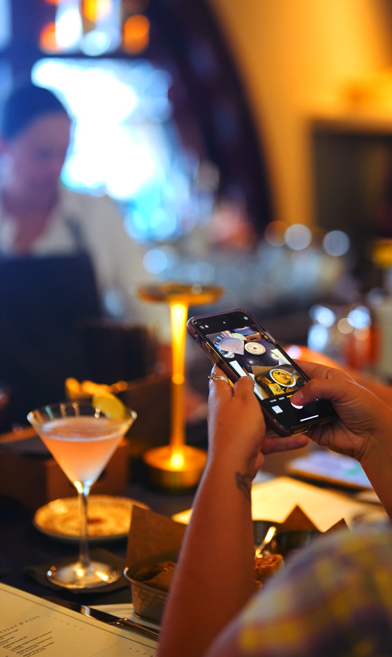a person holding a wine glass on a table