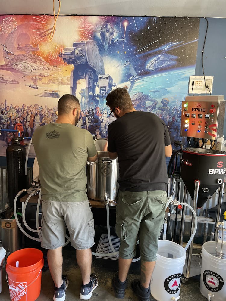 a group of people standing in a kitchen