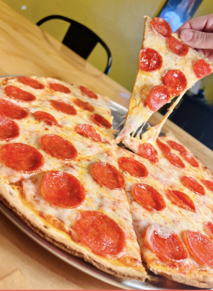 a pepperoni pizza sitting on top of a table