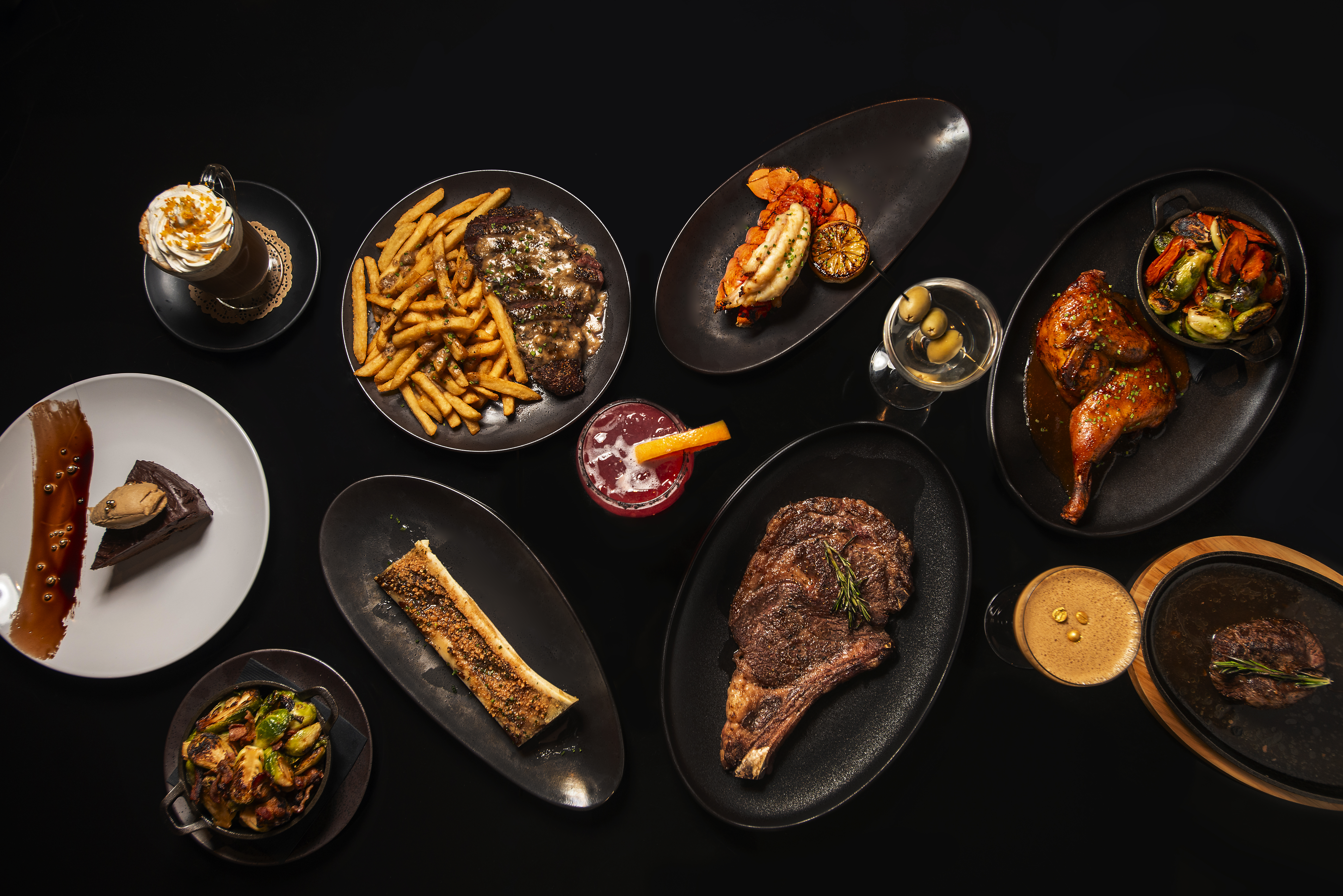 a table with plates of food and drinks