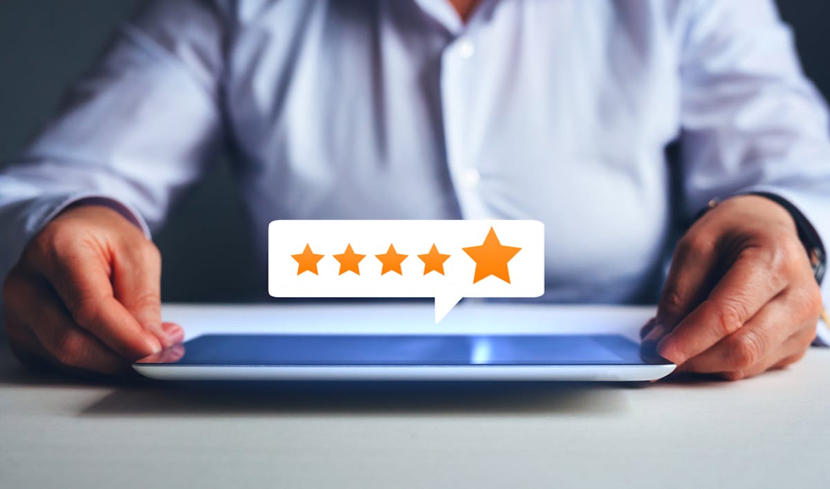 man leaving a review on an ipad