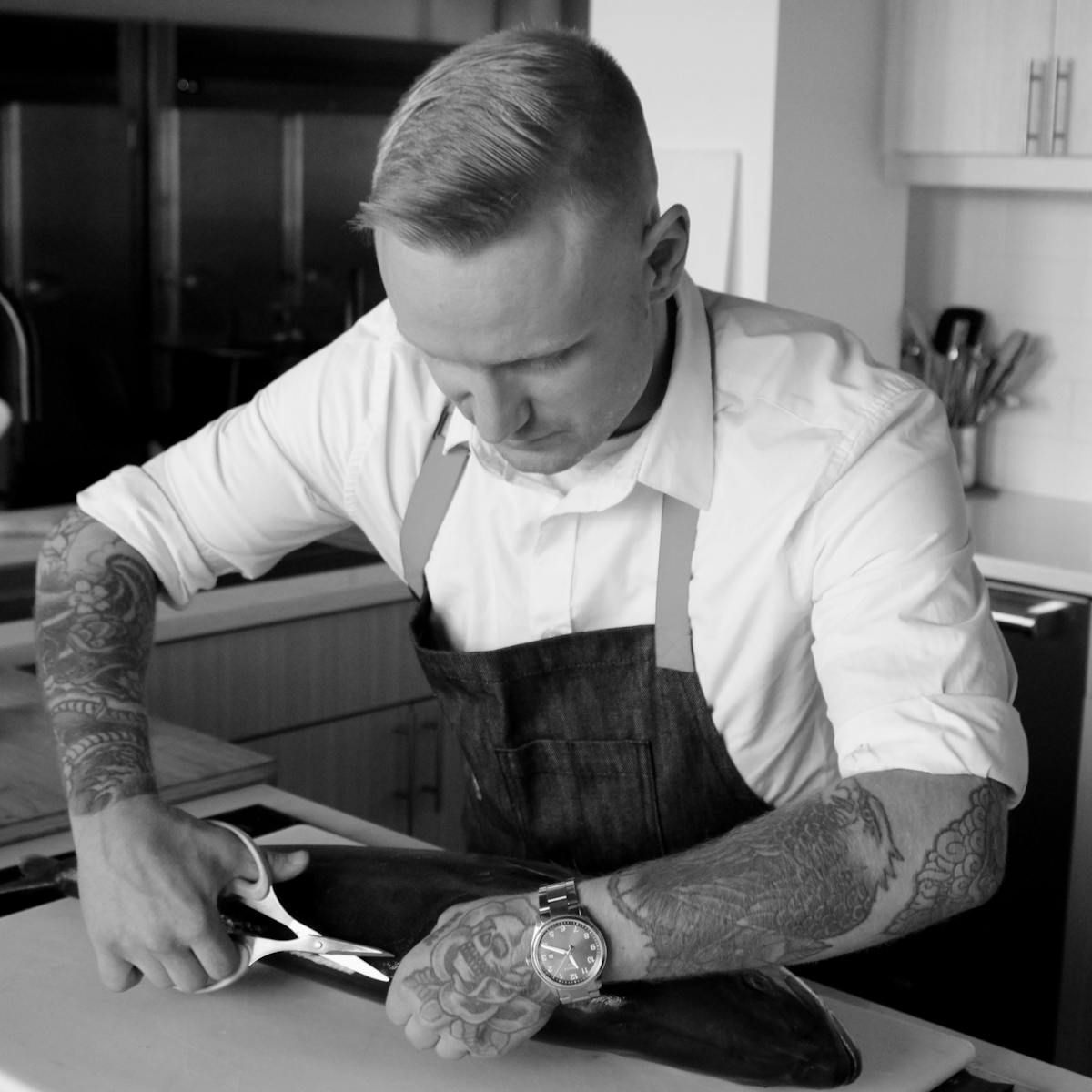 a man cutting food on a table