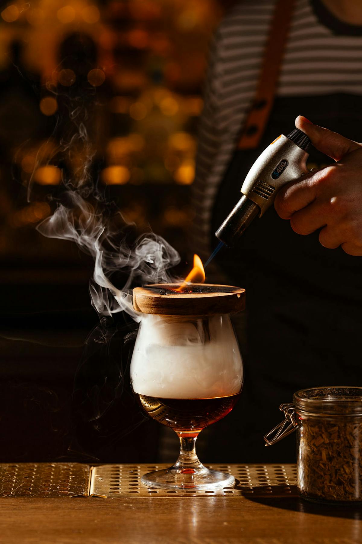 a glass of wine sitting on top of a wooden table