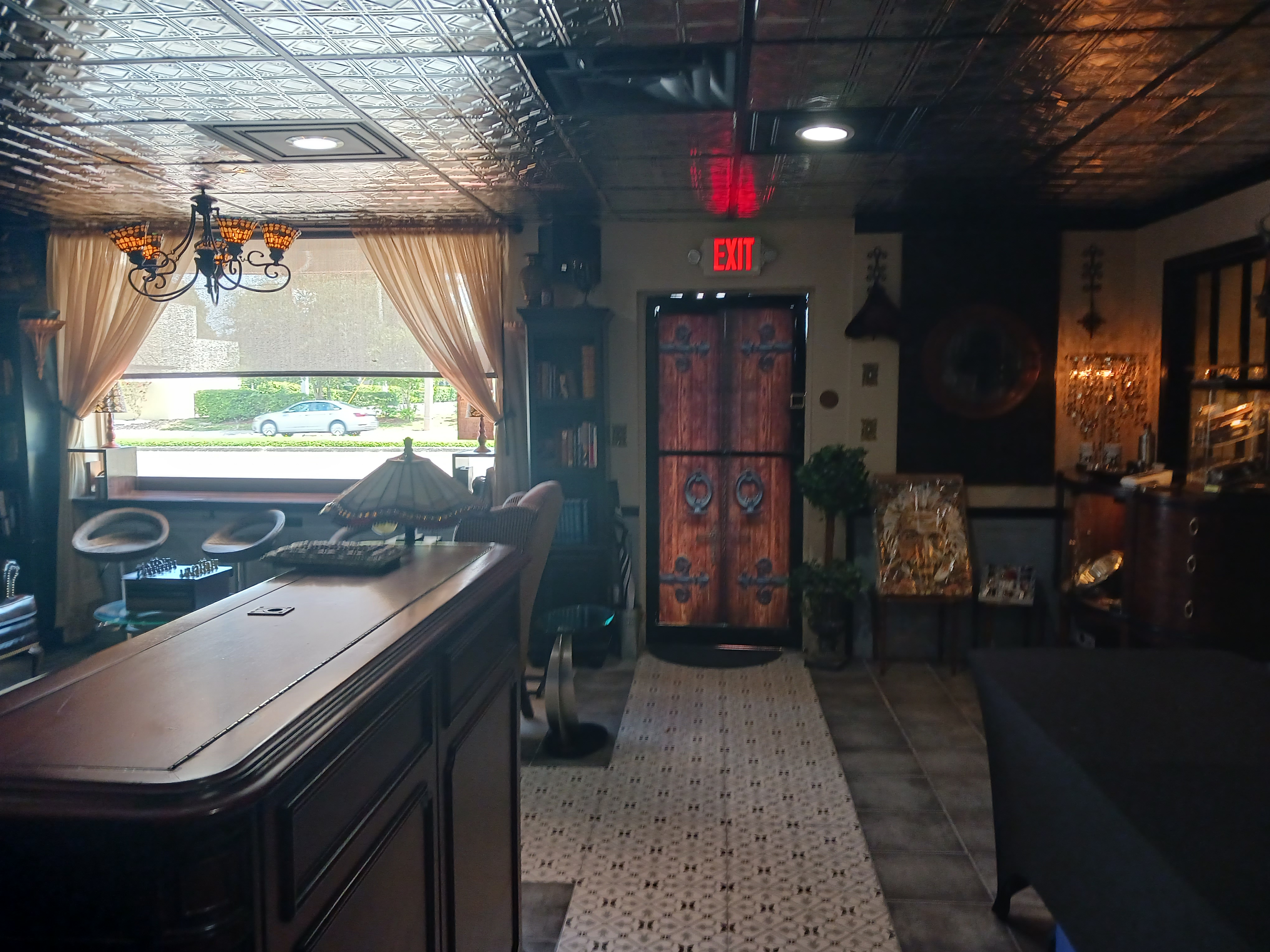 A stylish salon featuring a bar area and a large mirror, creating an inviting atmosphere for clients