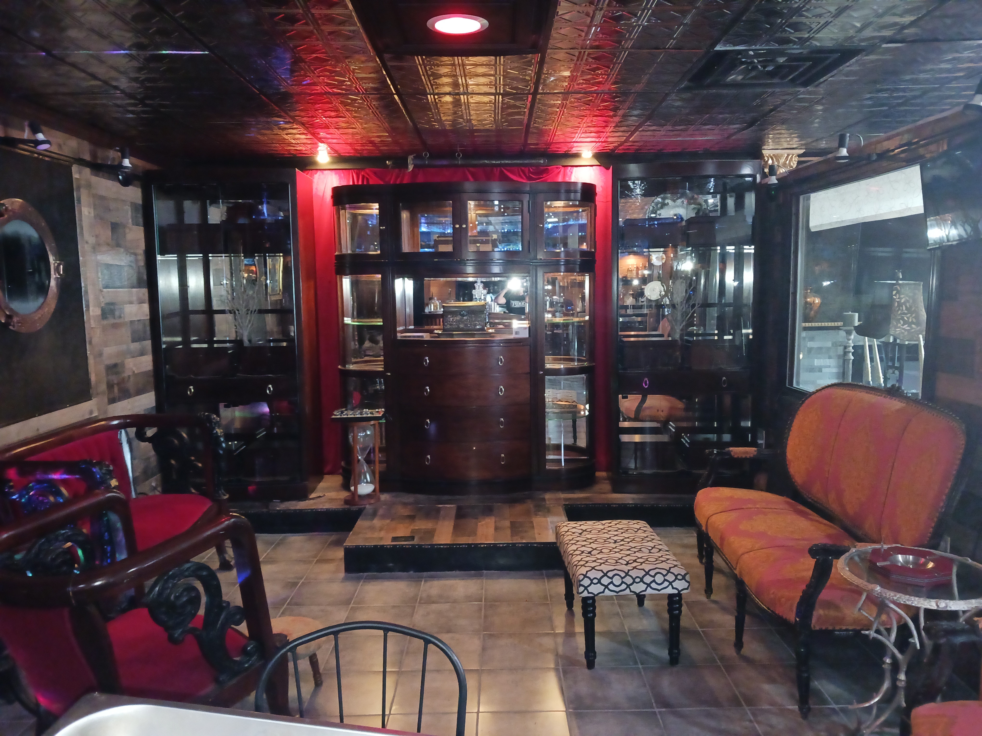 A cozy room featuring a bar, comfortable couches, and a stylish table for social gatherings