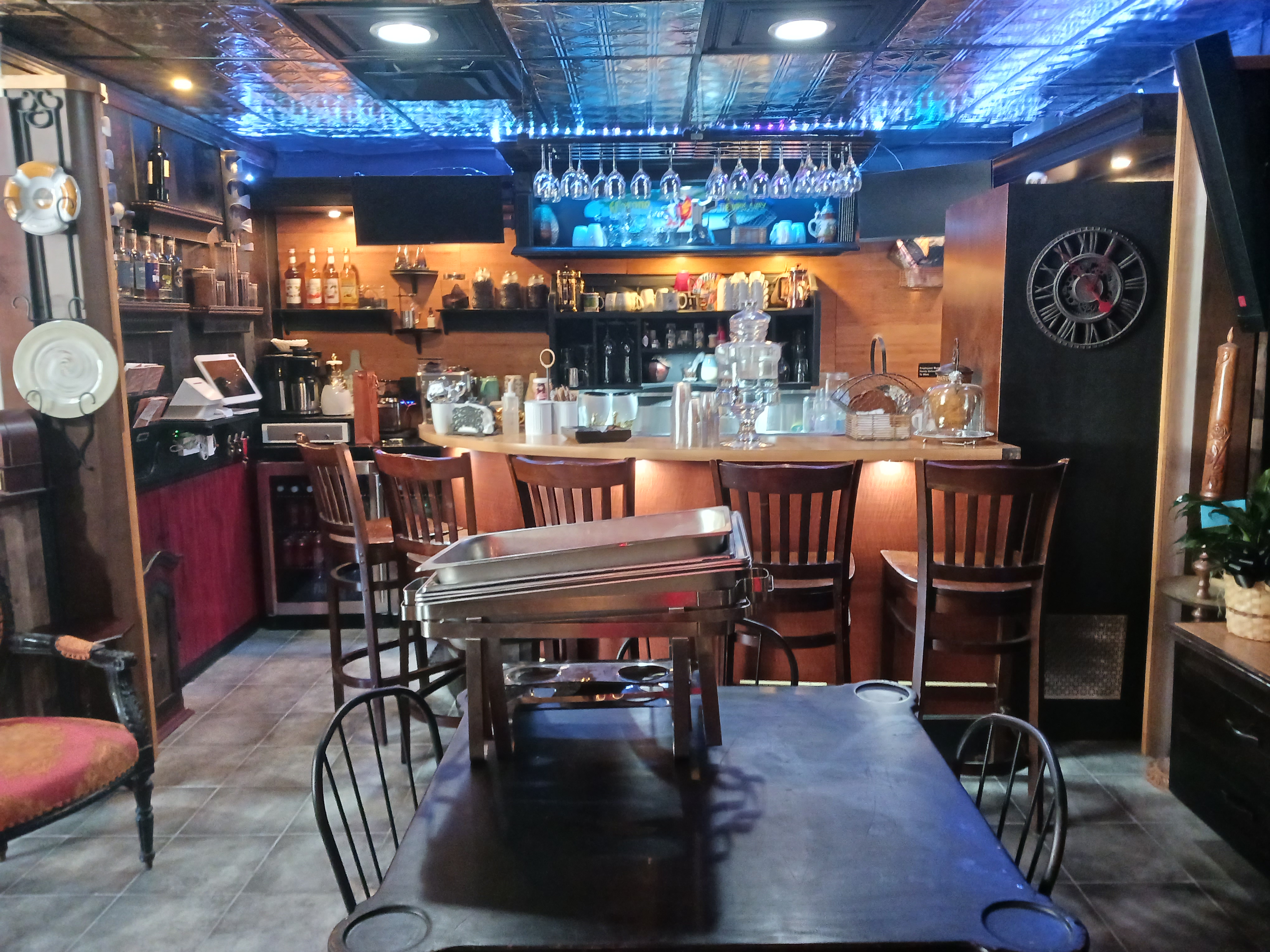 A cozy room featuring a bar, comfortable couches, and a stylish table for social gatherings