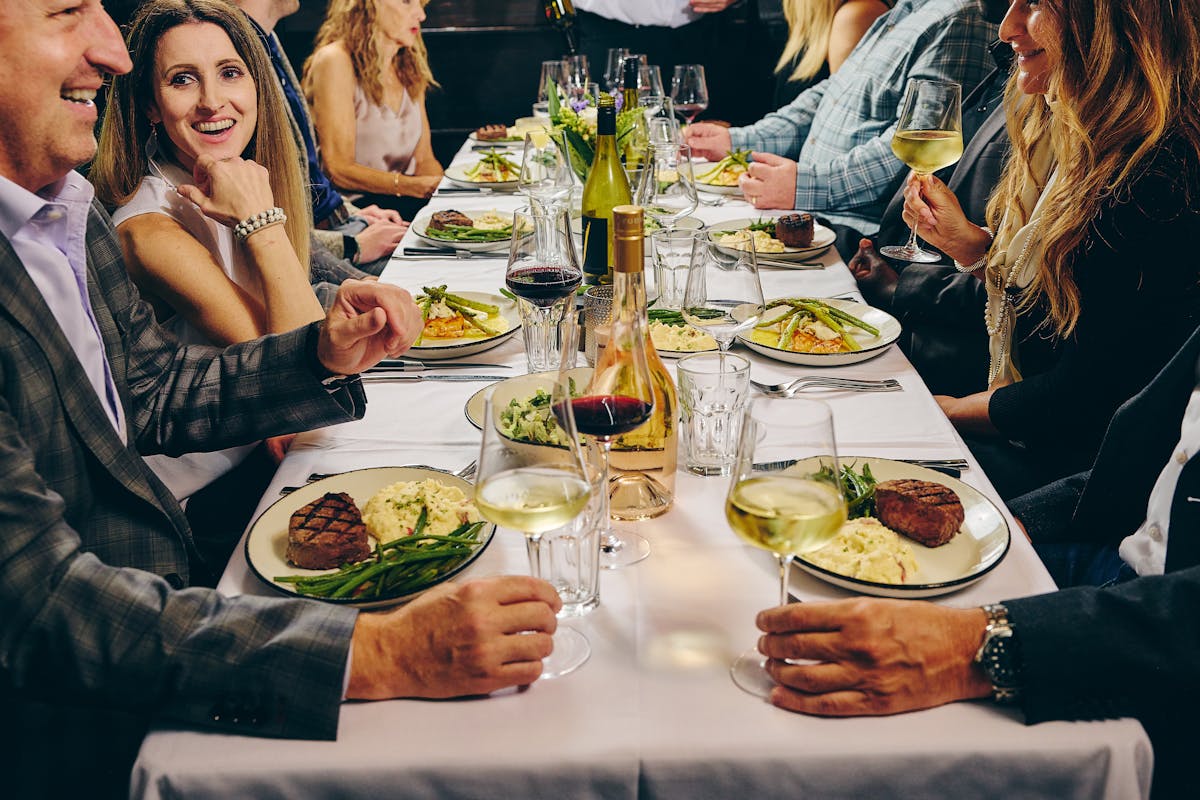 a group of people sitting at a dinner table