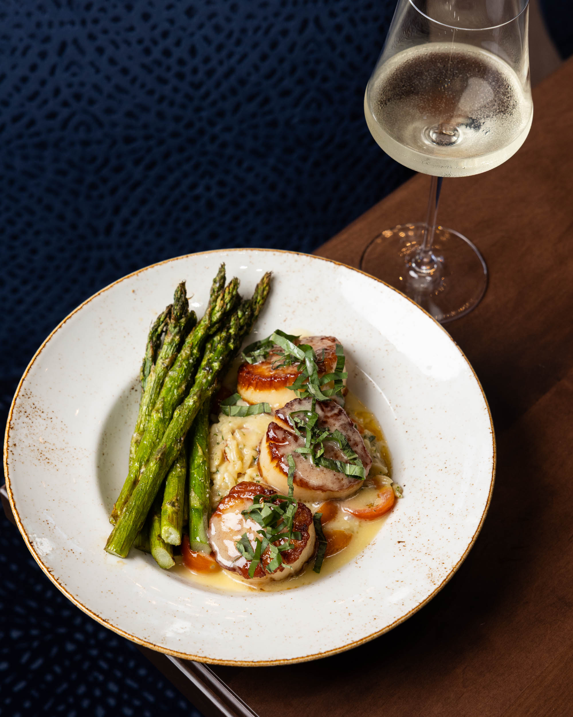 a plate of food and a glass of wine