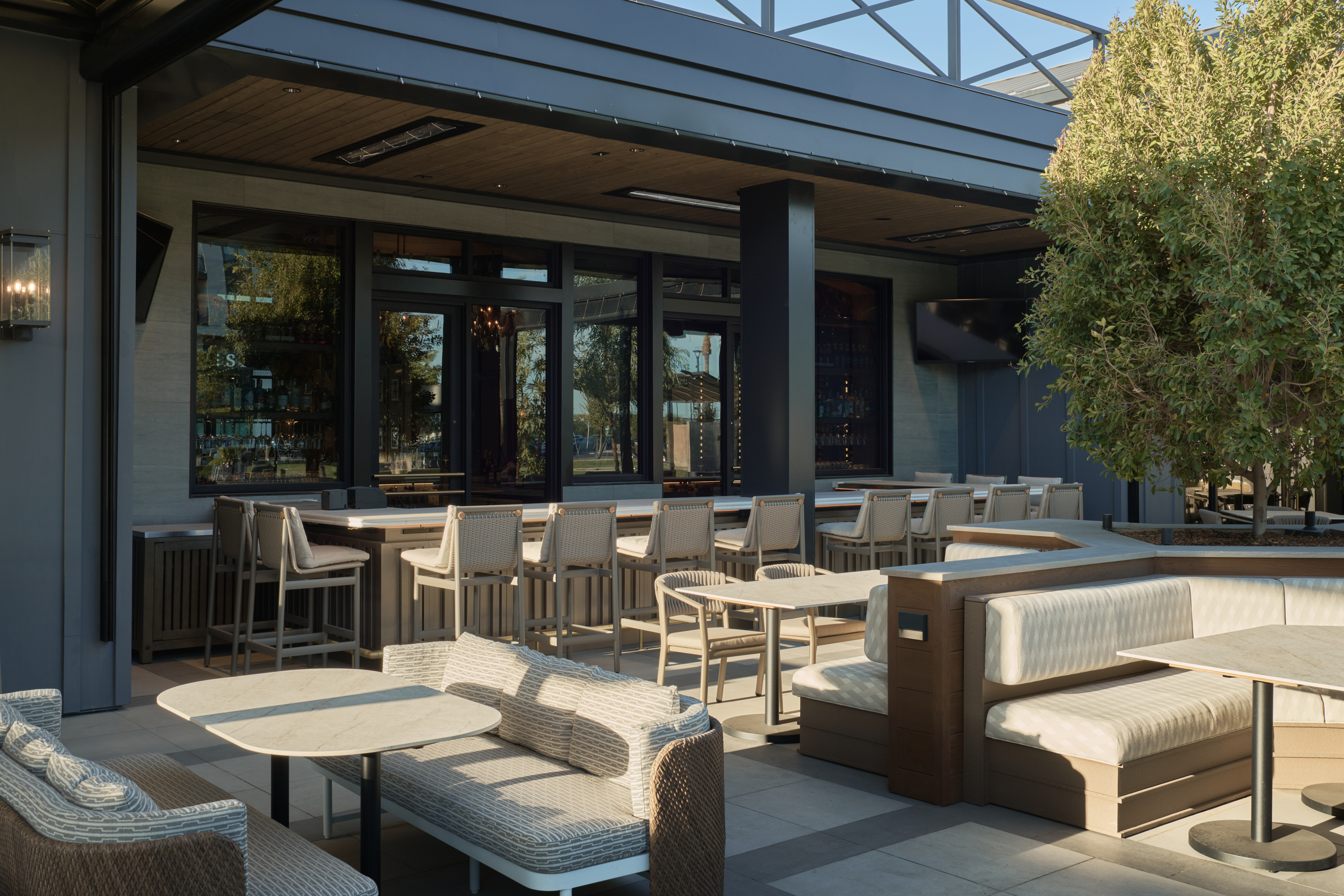 a patio with tables and chairs