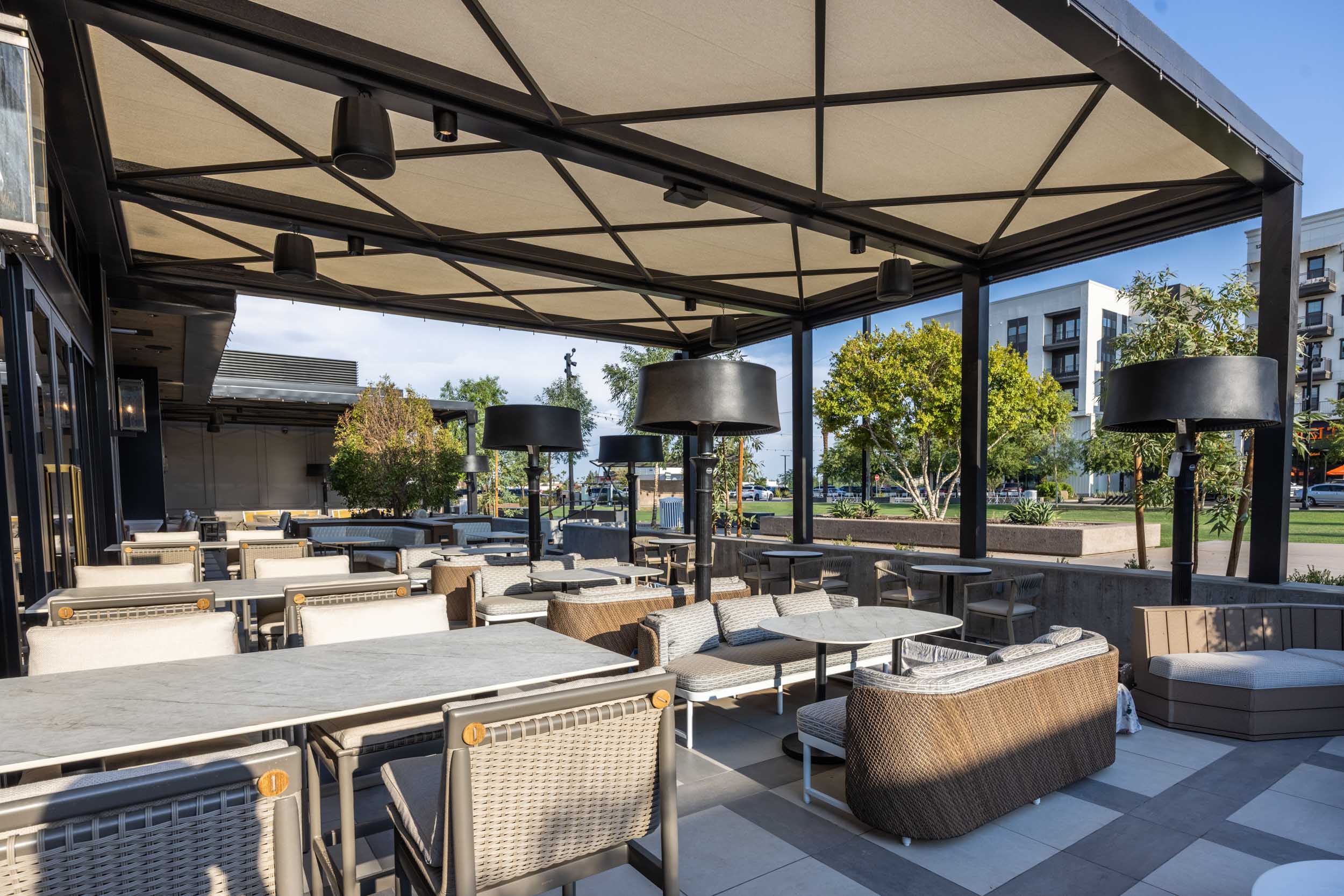 a patio with tables and chairs