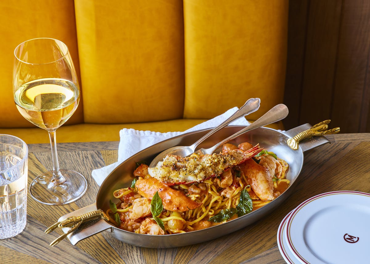 a plate of food and a glass of wine