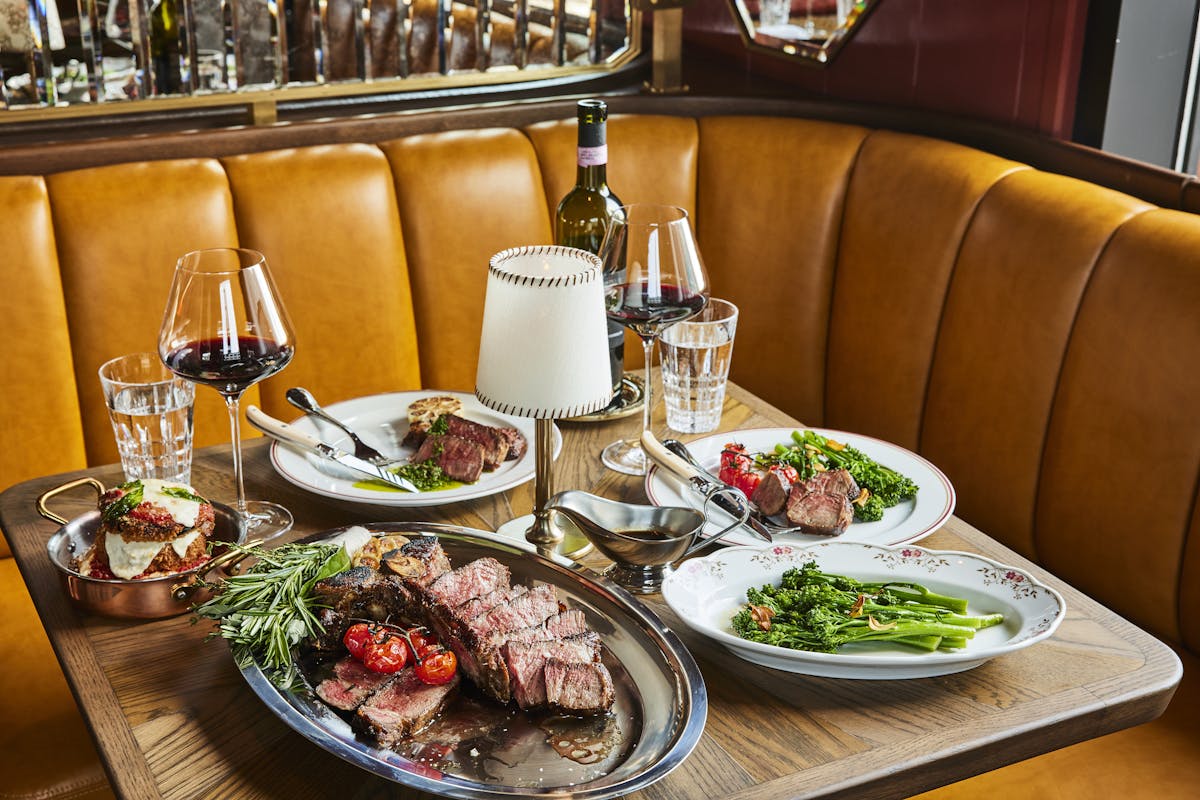 a plate full of food sitting on top of a wooden table