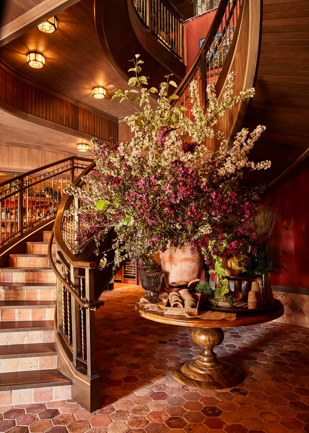 a room filled with furniture and vase of flowers on a table