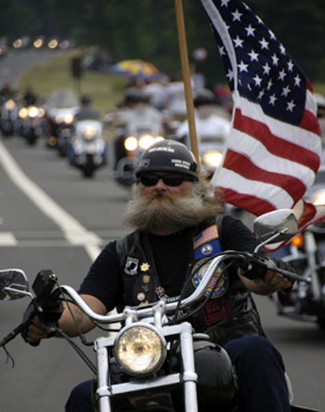 a man riding a motorcycle down a street