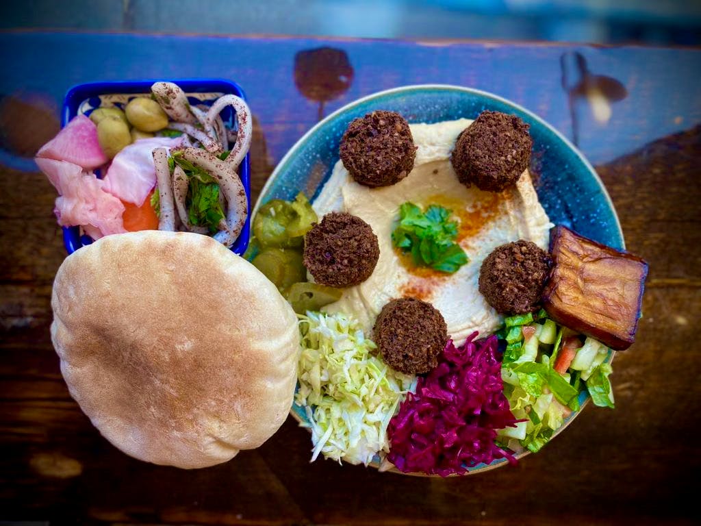 a group of stuffed animals sitting on top of a plate of food