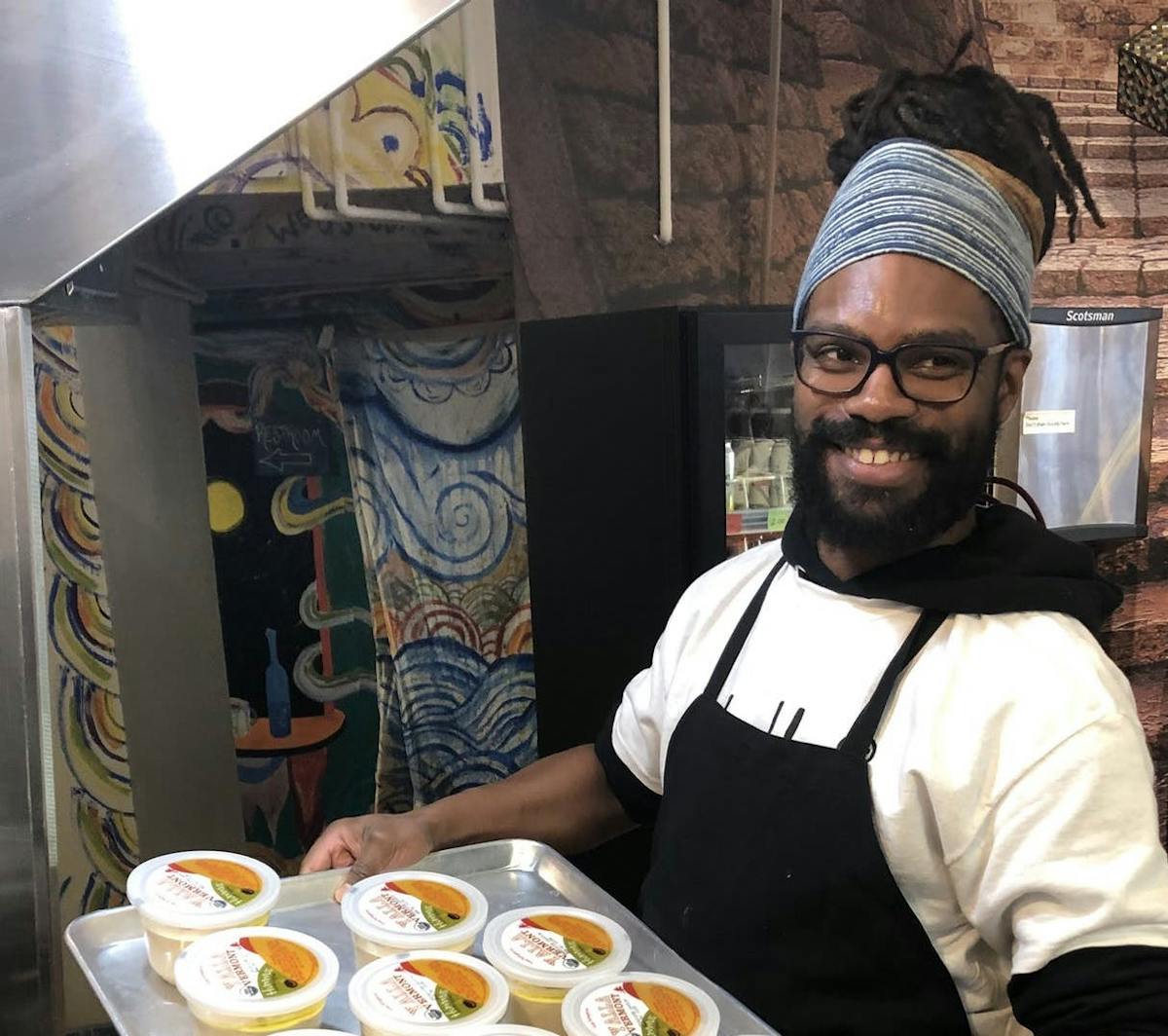 a person sitting at a table with a plate of food