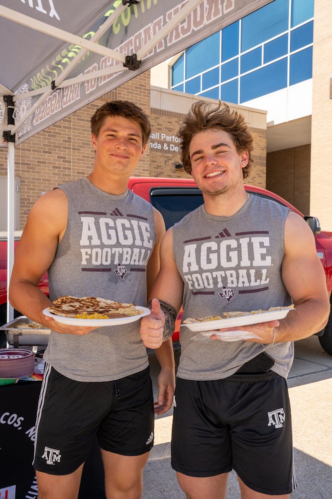 Michael Christie et al. standing in front of a birthday cake