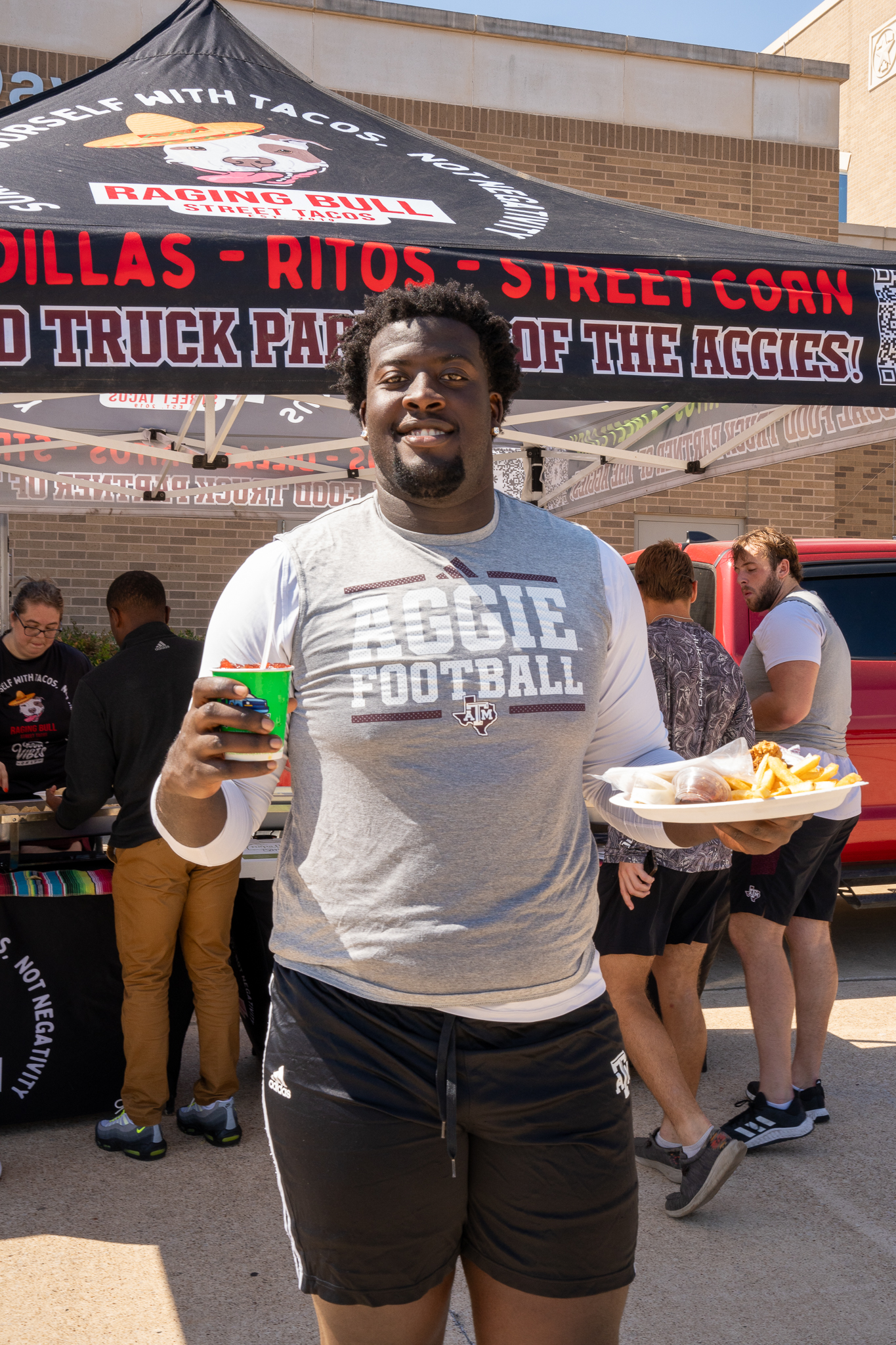 Sylvan LaCue et al. standing in front of a building